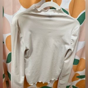 Mock neck lettuce edge top